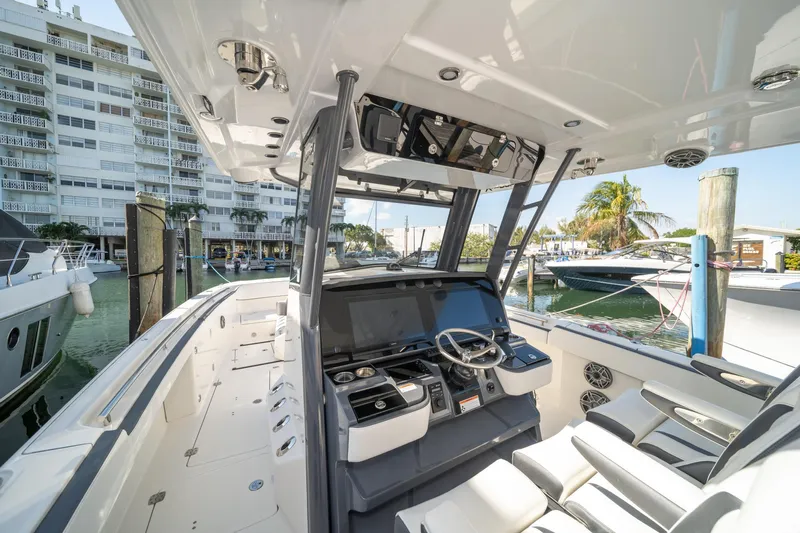  Yacht Photos Pics 2022 World Cat 400 CC-X boat interior at marina, featuring modern helm and seating.