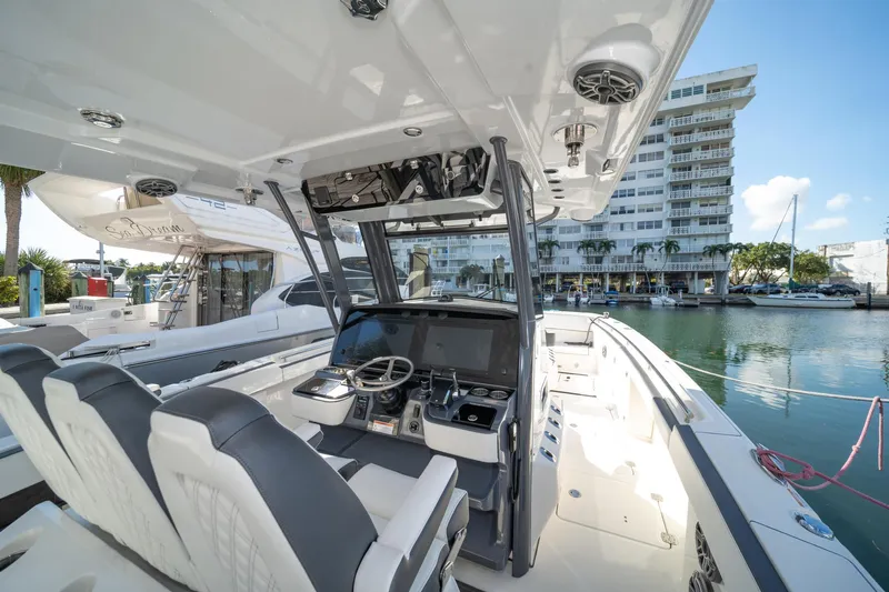 Yacht Photos Pics 2022 World Cat 400 CC-X boat interior at marina, featuring modern helm and seating.