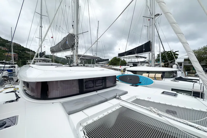Island Riff Yacht Photos Pics 2025 Lagoon 42 catamaran docked, featuring sleek design and modern amenities.