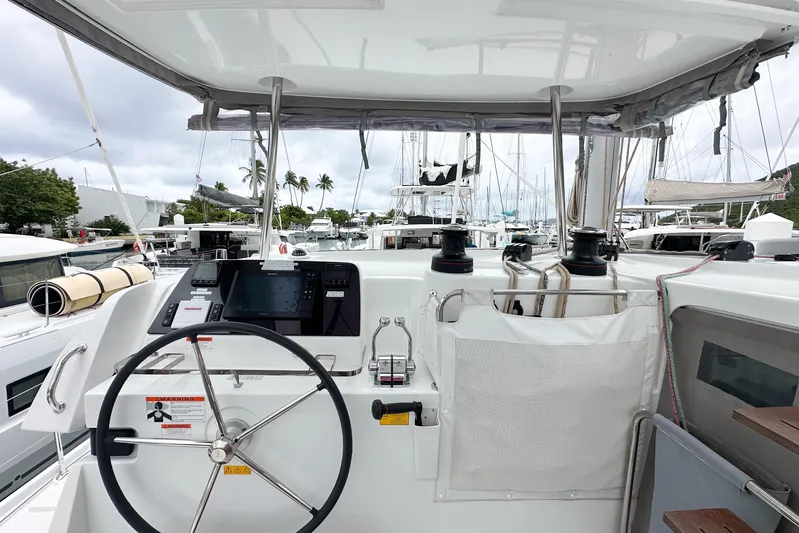 Island Riff Yacht Photos Pics 2025 Lagoon 42 yacht helm with navigation equipment and marina view.