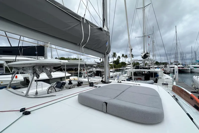 Island Riff Yacht Photos Pics 2025 Lagoon 42 catamaran docked at marina, featuring spacious deck and modern design.
