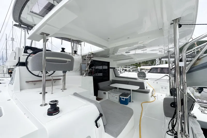 Island Riff Yacht Photos Pics 2025 Lagoon 42 catamaran cockpit with seating, helm station, and modern design.