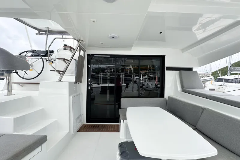 Island Riff Yacht Photos Pics 2025 Lagoon 42 yacht interior with modern seating and helm station.