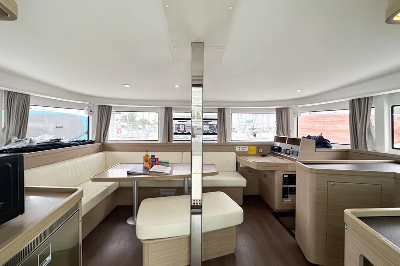 Island Riff Yacht Photos Pics Modern interior of 2025 Lagoon 42 catamaran with spacious seating and dining area.