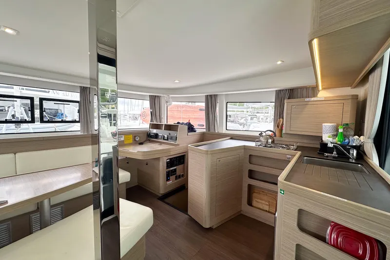 Island Riff Yacht Photos Pics Modern interior of 2025 Lagoon 42 catamaran with spacious kitchen and dining area.