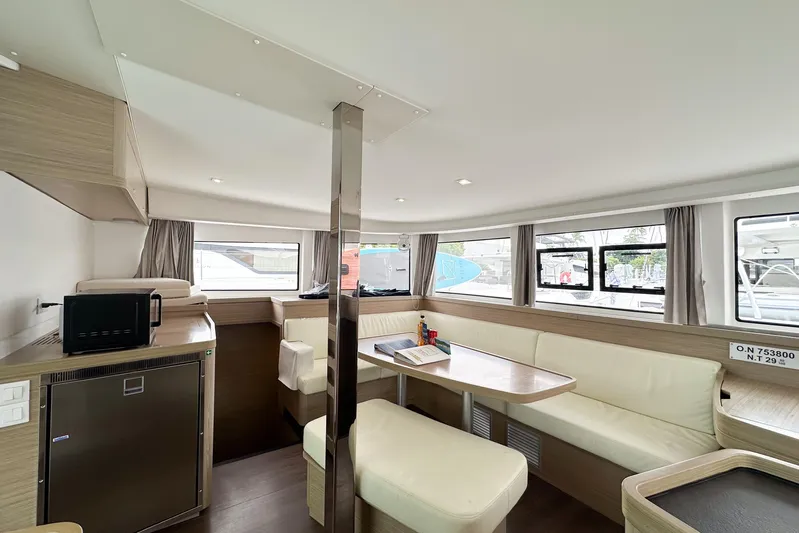 Island Riff Yacht Photos Pics Interior of 2025 Lagoon 42 catamaran with modern seating and kitchen area.