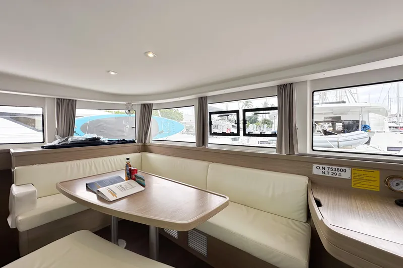 Island Riff Yacht Photos Pics Interior of 2025 Lagoon 42 catamaran with dining area and large windows.