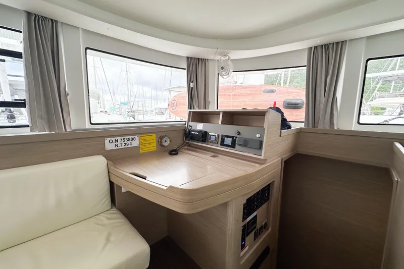 Island Riff Yacht Photos Pics Interior of 2025 Lagoon 42 catamaran with navigation station and large windows.