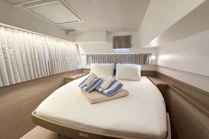 Island Riff Yacht Photos Pics 2025 Lagoon 42 yacht interior cabin with cozy bed and elegant decor.