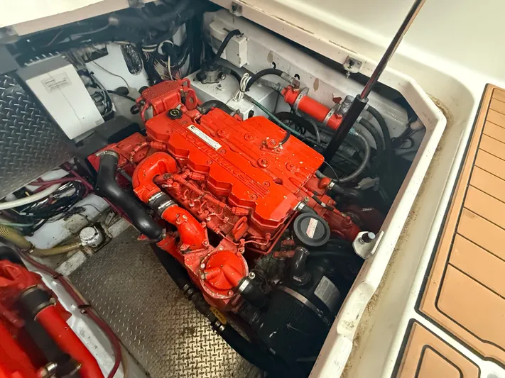 Wrangler Yacht Photos Pics Engine compartment of a 2003 Pursuit 3400 Express boat with red engine.