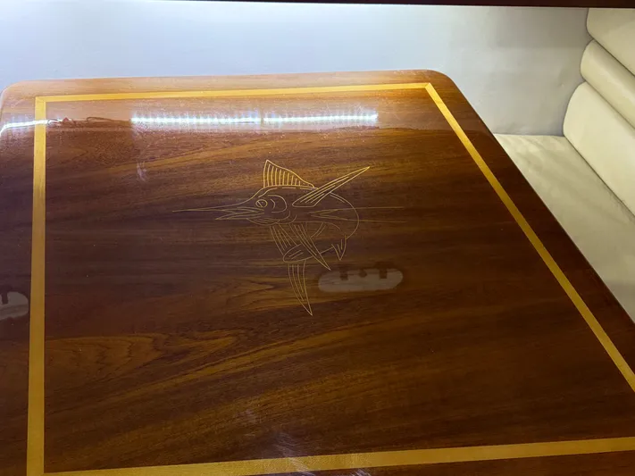 Wrangler Yacht Photos Pics Wooden table with inlaid fish design on Pursuit 3400 Express, 2003.