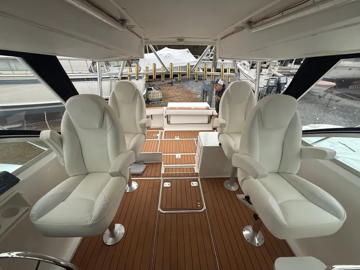 Wrangler Yacht Photos Pics Interior of 2003 Pursuit 3400 Express with four white seats.