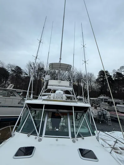 Wrangler Yacht Photos Pics 2003 Pursuit 3400 Express boat docked, cloudy sky.