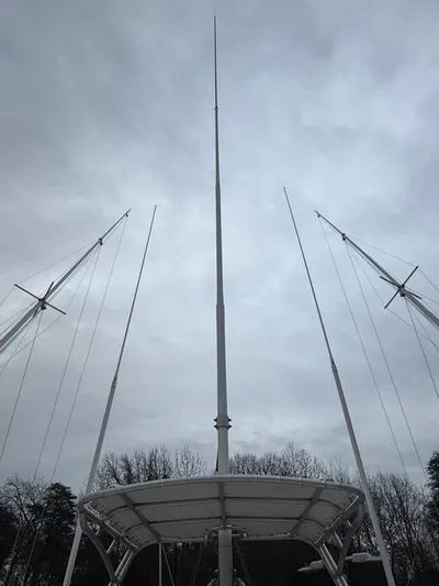 Wrangler Yacht Photos Pics Masts of a 2003 Pursuit 3400 Express boat against cloudy sky.