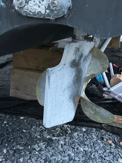 Wrangler Yacht Photos Pics 2003 Pursuit 3400 Express boat propeller on gravel surface.