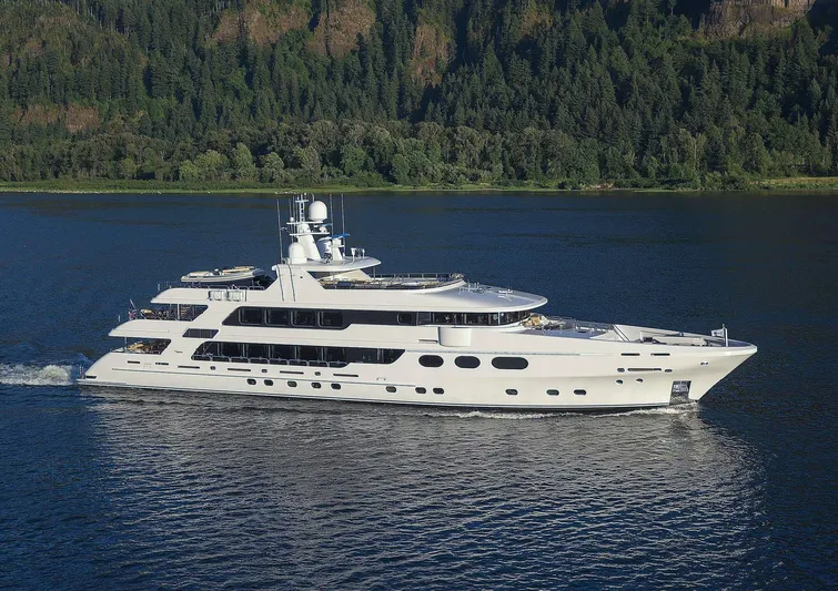 Jackpot Yacht Photos Pics Christensen Model Year 2020 luxury yacht cruising on a serene lake with forested hills in the background.