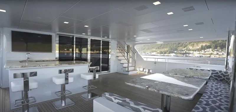 Jackpot Yacht Photos Pics Luxurious interior of Christensen Model Year 2020 yacht with modern bar and seating area.