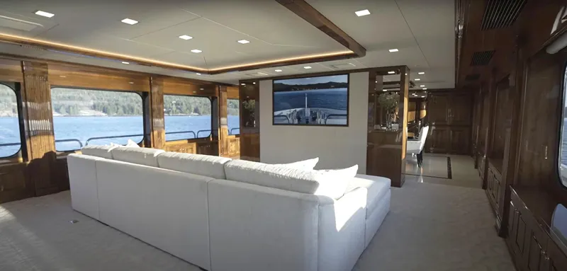 Jackpot Yacht Photos Pics Luxurious interior of Christensen Model Year 2020 yacht with large windows and white sofa.