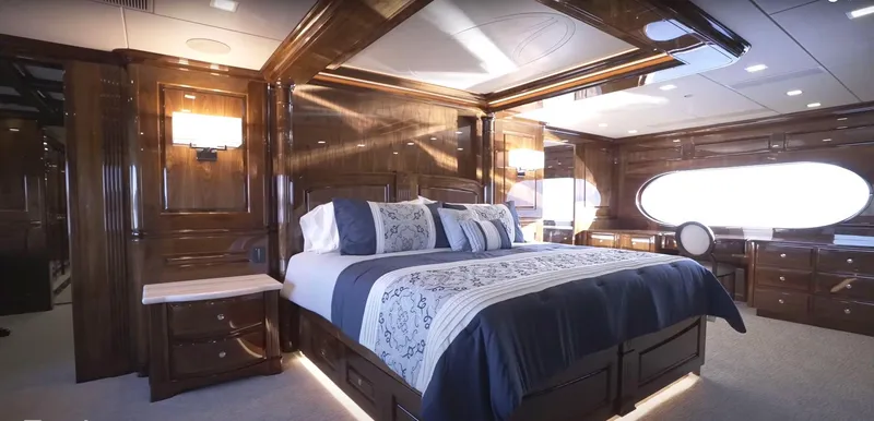 Jackpot Yacht Photos Pics Luxurious Christensen 2020 yacht bedroom with elegant wood paneling and modern lighting.