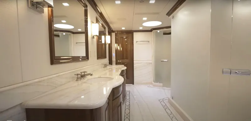 Jackpot Yacht Photos Pics Luxurious Christensen 2020 yacht bathroom with double sinks, marble countertops, and modern lighting.