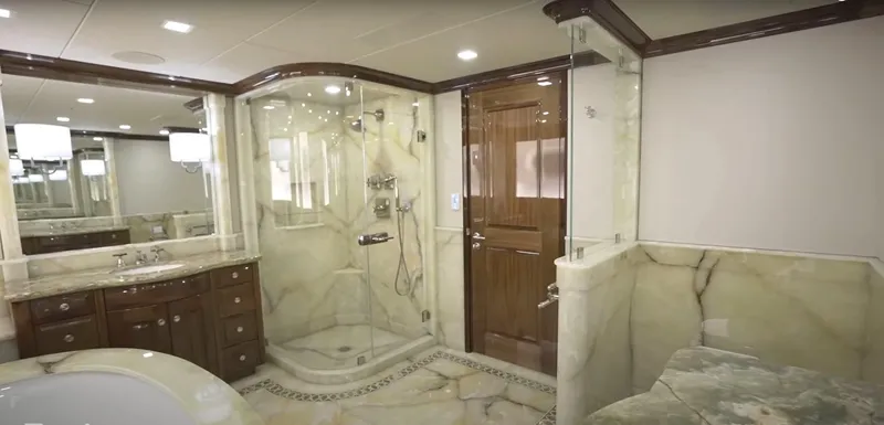 Jackpot Yacht Photos Pics Luxurious marble bathroom in Christensen Model Year 2020 yacht, featuring glass shower and wooden accents.