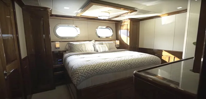 Jackpot Yacht Photos Pics Luxurious bedroom interior of Christensen Model Year 2020 yacht with elegant wood finishes.