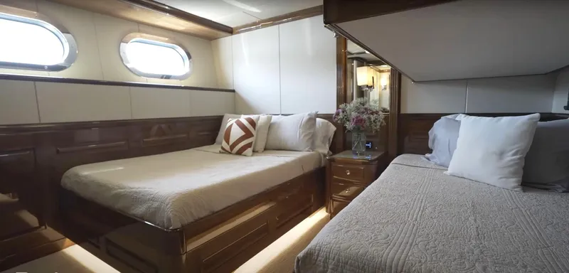 Jackpot Yacht Photos Pics Luxurious bedroom in Christensen Model Year 2020 yacht with twin beds and elegant decor.