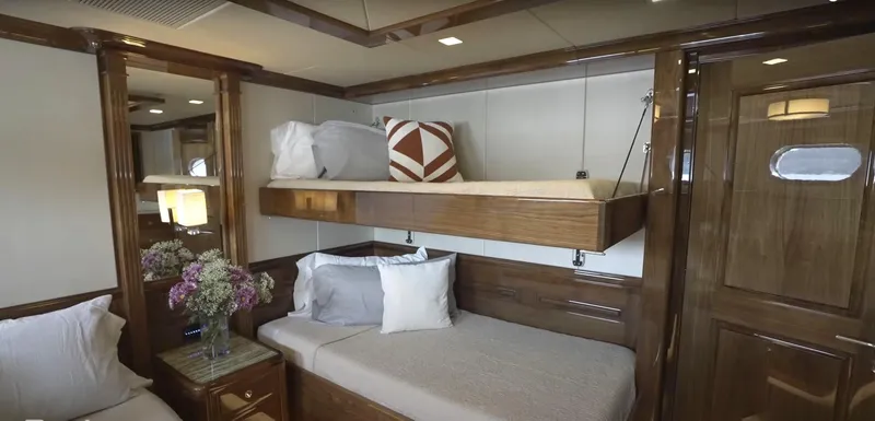 Jackpot Yacht Photos Pics Luxurious 2020 Christensen yacht cabin with bunk beds and elegant wooden interior.