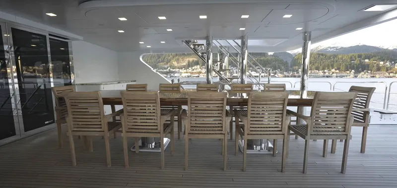 Jackpot Yacht Photos Pics Luxury yacht deck with wooden dining table and chairs, Christensen Model Year 2020.