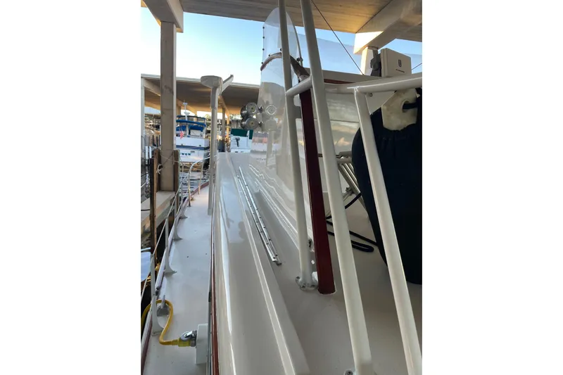 Mnm Yacht Photos Pics 1958 Huckins Seafarer boat docked, showcasing sleek deck and railing design.