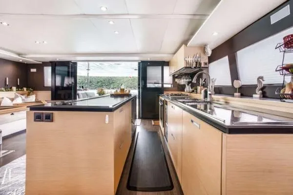 Lena Yacht Photos Pics Luxurious kitchen interior of 2017 Lagoon 63 Power yacht with modern amenities and sleek design.