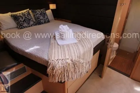 Lena Yacht Photos Pics Luxurious bedroom in 2017 Lagoon 63 Power yacht with cozy bedding and en-suite bathroom.