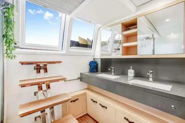 Lena Yacht Photos Pics Luxurious bathroom interior of 2017 Lagoon 63 Power yacht with dual sinks and modern design.