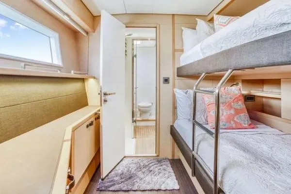 Lena Yacht Photos Pics Luxurious cabin interior of 2017 Lagoon 63 Power yacht with bunk beds and ensuite bathroom.