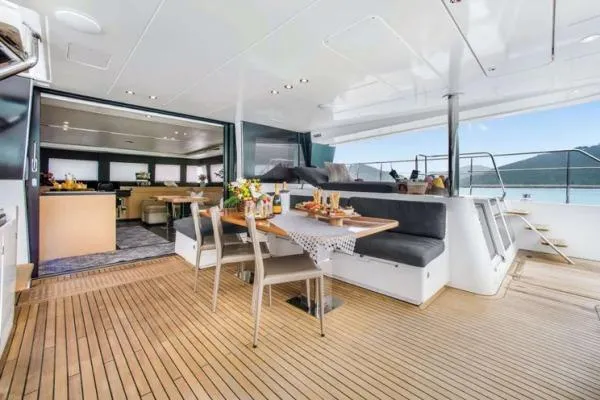 Lena Yacht Photos Pics Luxurious 2017 Lagoon 63 Power yacht with elegant outdoor dining area and scenic views.