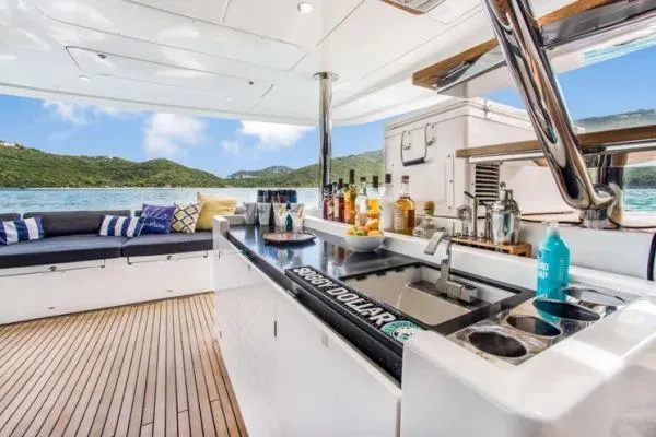 Lena Yacht Photos Pics Luxurious 2017 Lagoon 63 Power yacht interior with bar, seating, and scenic ocean view.