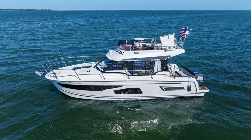 Trinity Yacht Photos Pics 2020 Jeanneau NC 1095 Fly yacht cruising on open water.