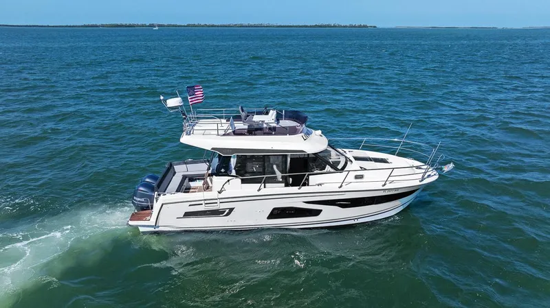 Trinity Yacht Photos Pics 2020 Jeanneau NC 1095 Fly cruising on open water, side view.