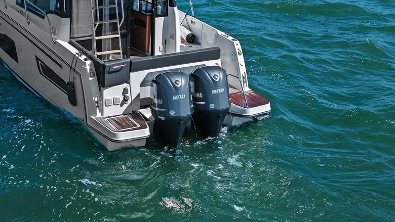 Trinity Yacht Photos Pics 2020 Jeanneau NC 1095 Fly with dual outboard engines on open water.