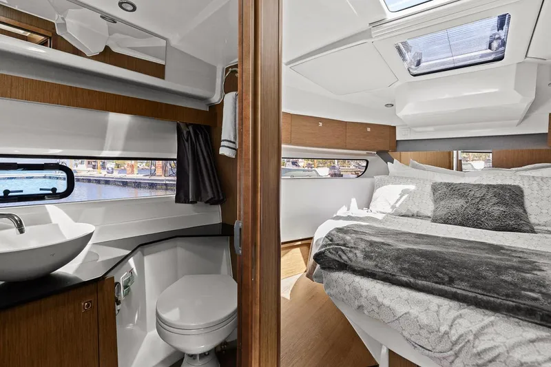 Trinity Yacht Photos Pics 2020 Jeanneau NC 1095 Fly interior with modern bathroom and cozy bedroom.