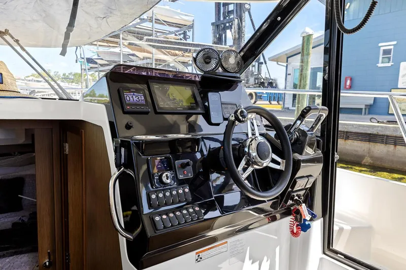 Trinity Yacht Photos Pics 2020 Jeanneau NC 1095 Fly boat cockpit with modern steering and navigation controls.