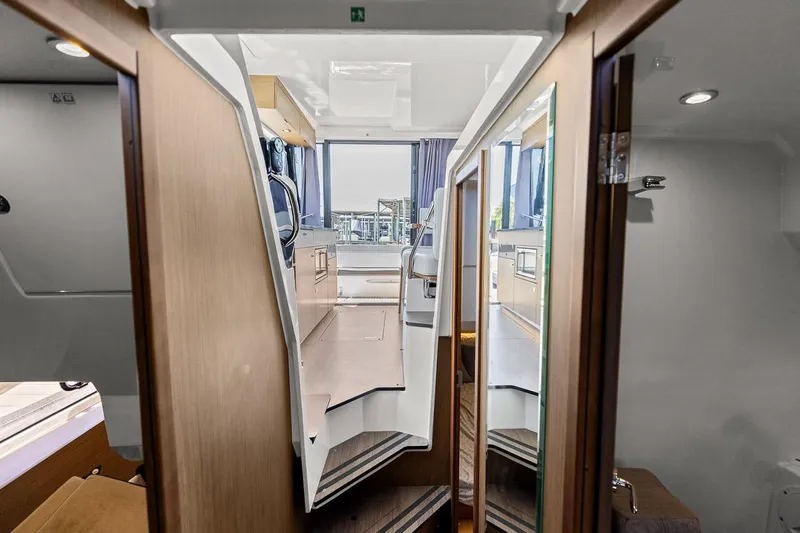 Trinity Yacht Photos Pics Interior view of 2020 Jeanneau NC 1095 Fly yacht, featuring modern design and wood finishes.