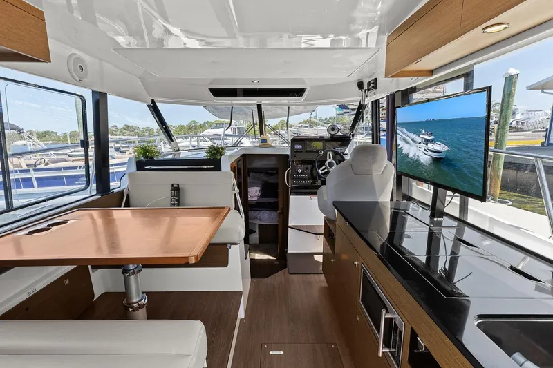 Trinity Yacht Photos Pics Interior of 2020 Jeanneau NC 1095 Fly yacht with modern amenities and panoramic windows.