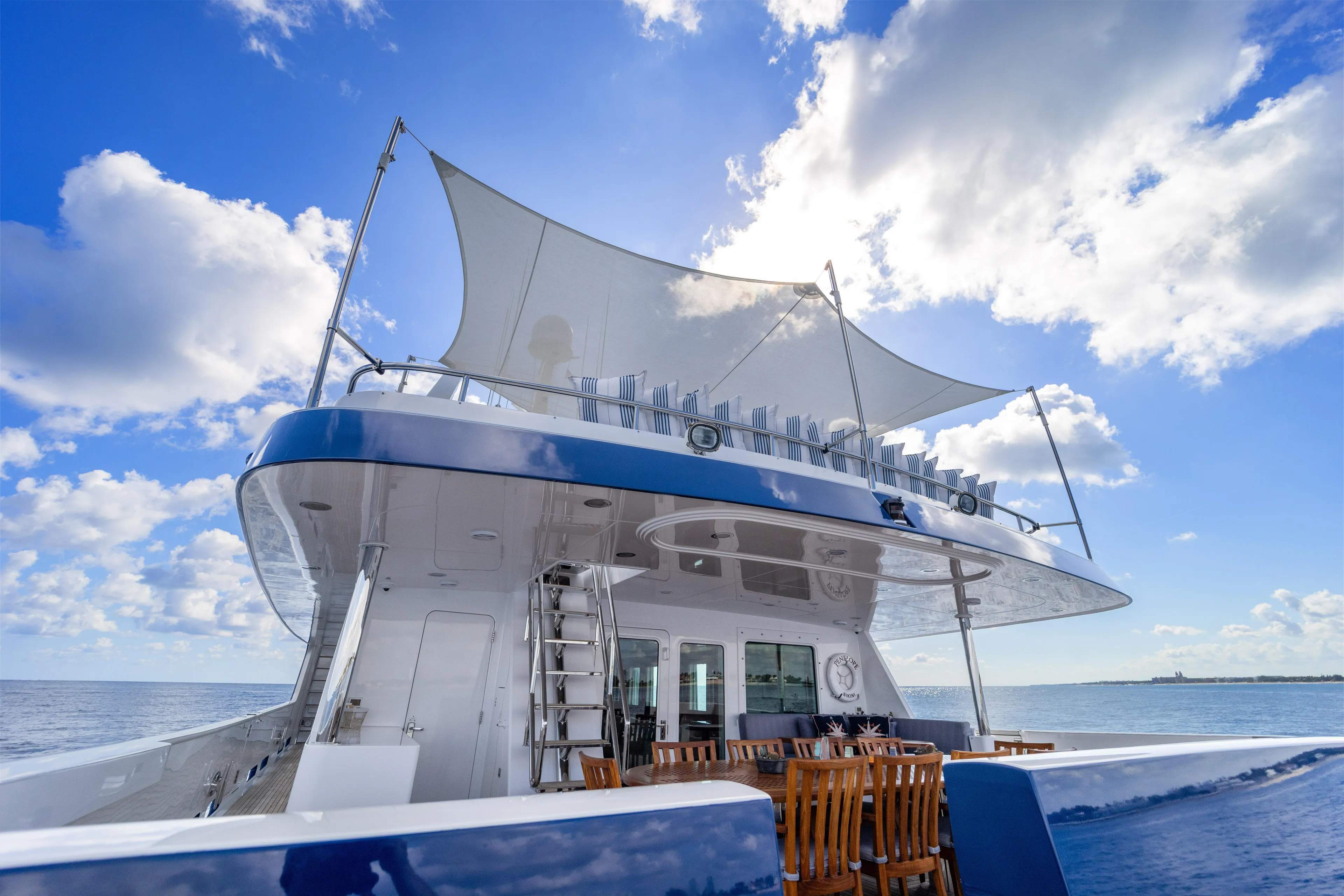 Penelope Yacht Photos Pics 1990 Delta Expedition yacht with sunshade, ocean view, and clear blue sky.