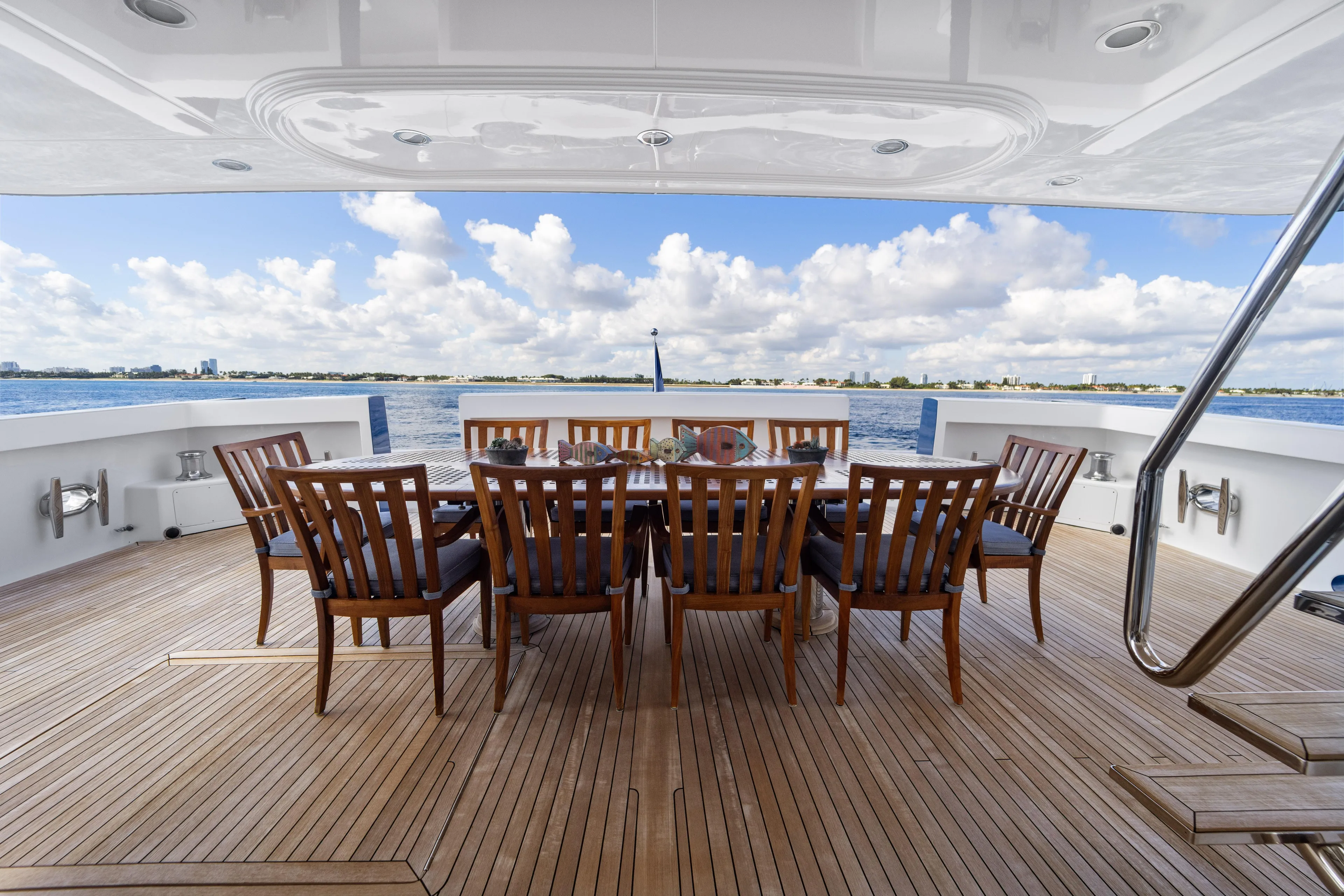 Penelope Yacht Photos Pics Luxury yacht deck with dining table, wooden chairs, ocean view; Delta Expedition 1990.