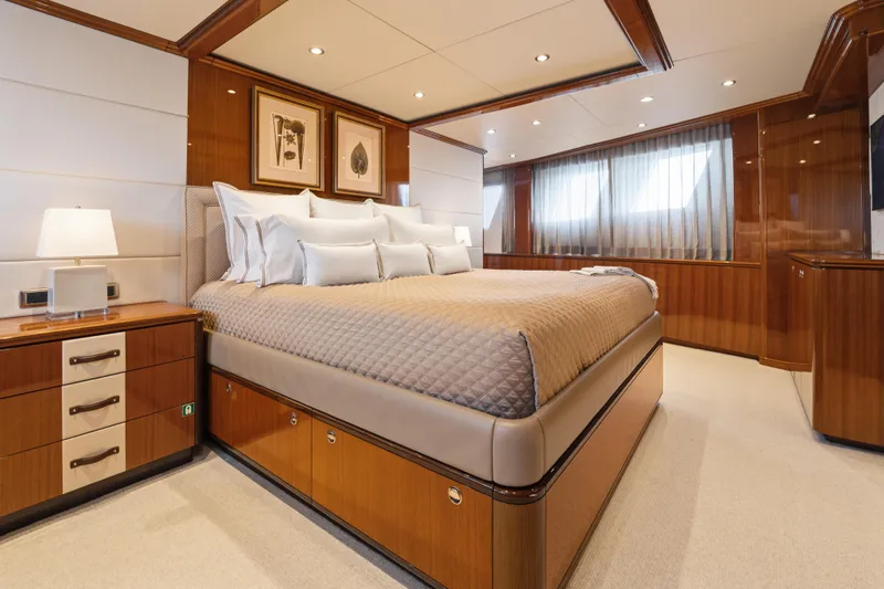 Penelope Yacht Photos Pics Luxurious bedroom interior on 1990 Delta Expedition yacht, featuring elegant wood paneling and modern decor.