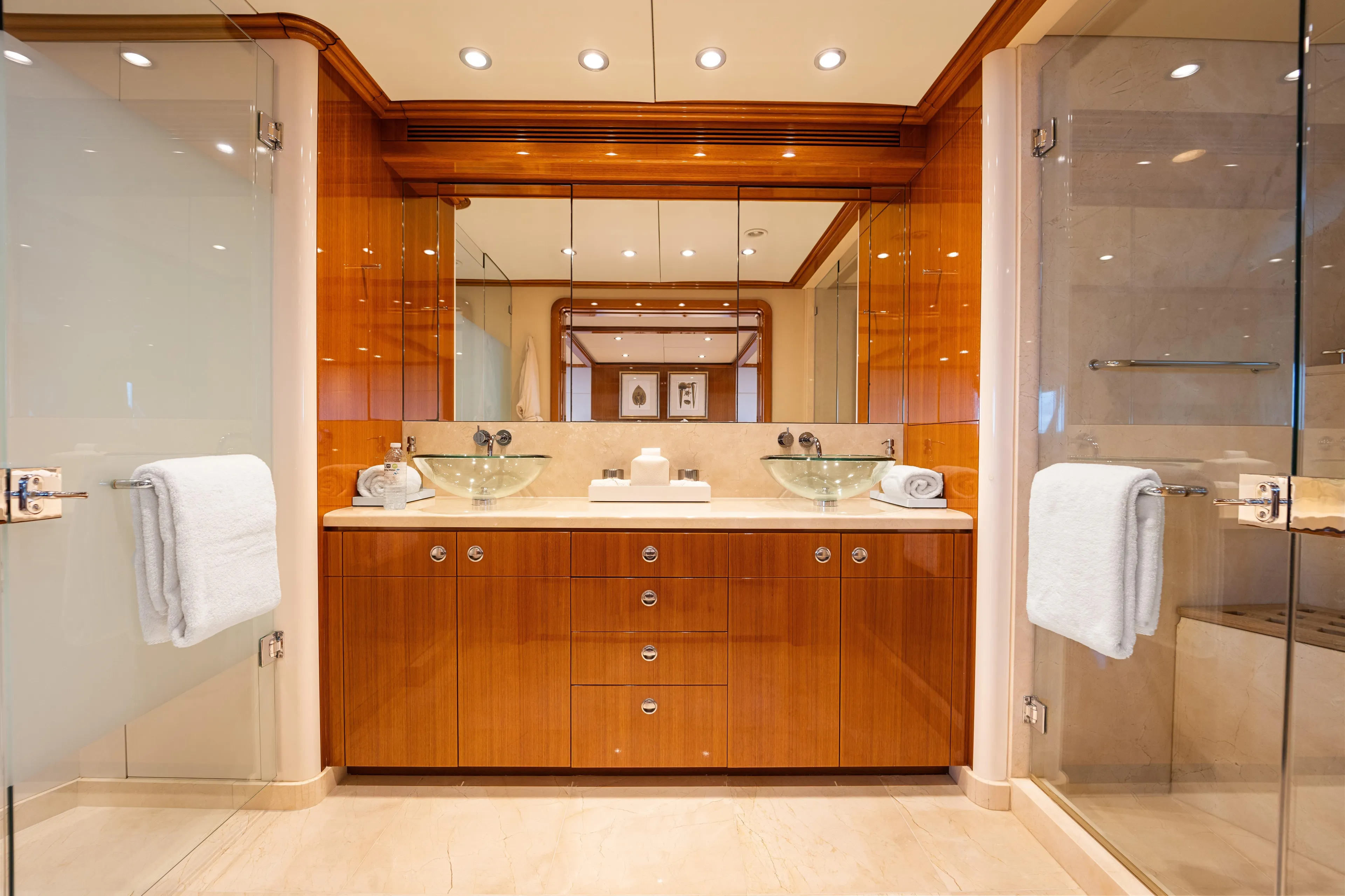 Penelope Yacht Photos Pics Luxurious yacht bathroom with glass sinks, wooden cabinetry, and elegant lighting, Delta Expedition 1990.