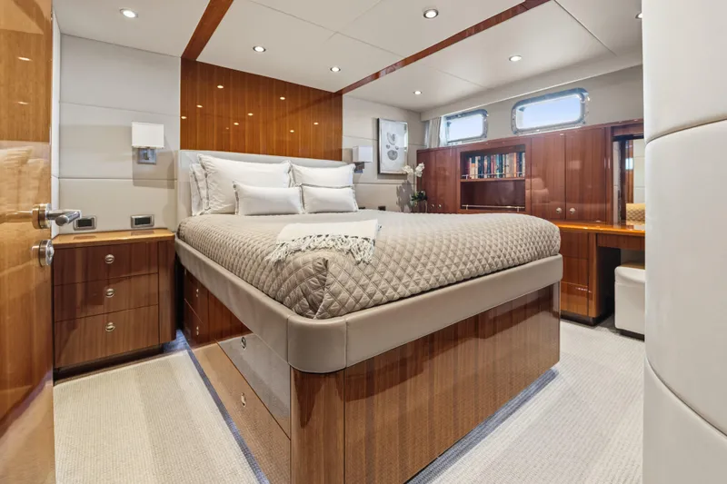 Penelope Yacht Photos Pics Luxurious cabin interior of 1990 Delta Expedition yacht with elegant wood finishes and cozy bedding.