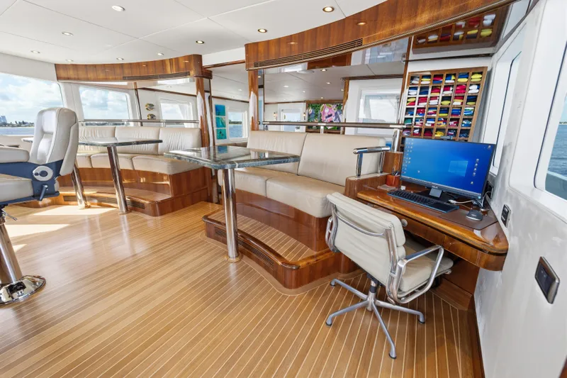 Penelope Yacht Photos Pics Luxurious interior of 1990 Delta Expedition yacht with seating, desk, and computer setup.