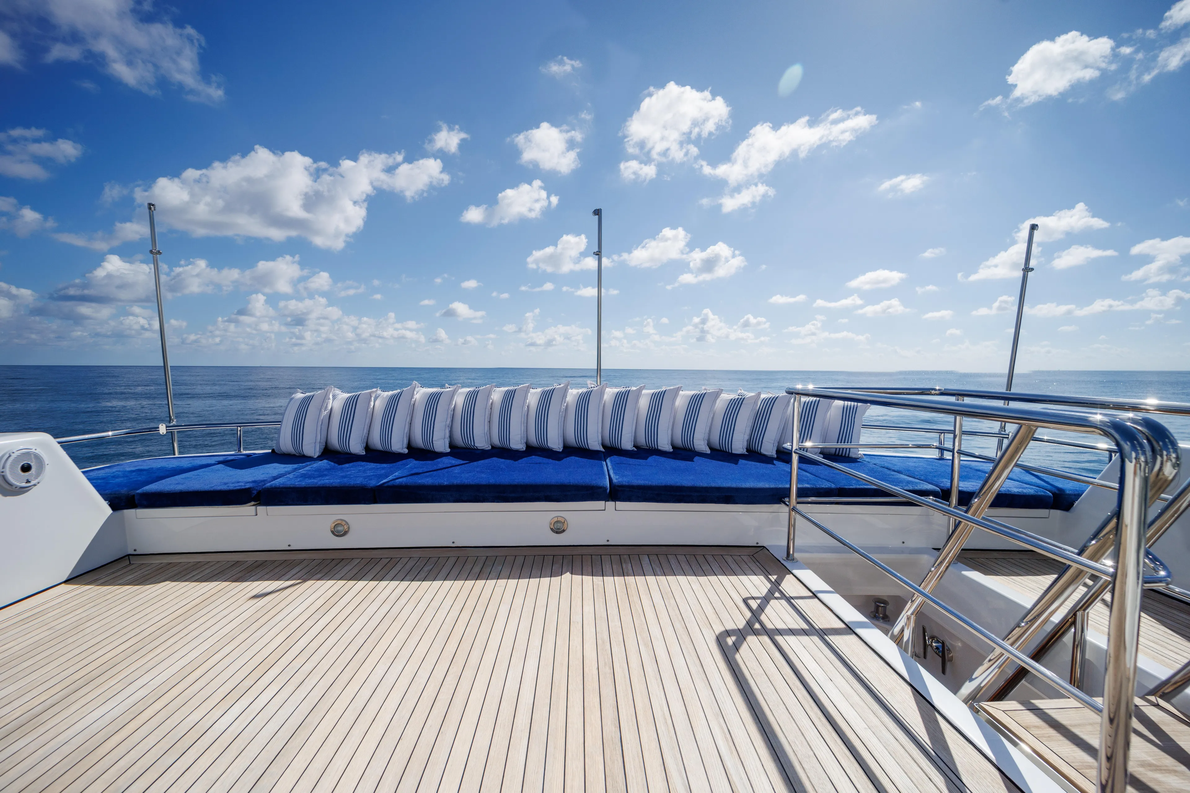 Penelope Yacht Photos Pics Luxurious deck of 1990 Delta Expedition yacht with blue cushions and ocean view.